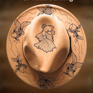 May include: Tan fedora hat with a hand-burned design of goldfish and the text "For Hand Burning" and "CoolMoonDesigns". The hat features a black band and a decorative fish pattern around the brim.