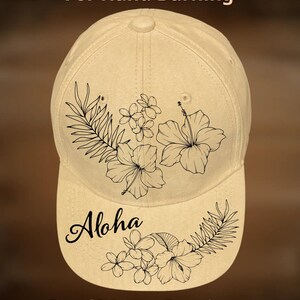 May include: Tan baseball cap with black floral and leaf design. The word "Aloha" is written on the brim. The text "For Hand Burning" and "CoolMoonDesigns" are also visible.