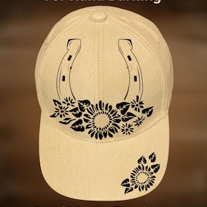May include: A beige baseball cap featuring a black graphic of a horseshoe surrounded by sunflowers and leaves. The text "For Hand Burning" appears at the top, and "CoolMoonDesigns" is printed at the bottom in a simple, dark font.