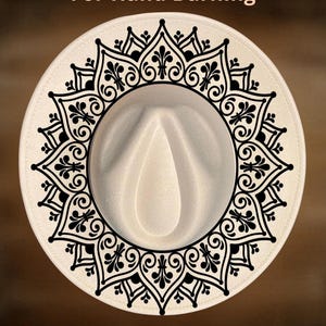 May include: A cream-colored fedora hat featuring a black circular mandala pattern printed on the brim. The text "For Hand Burning" appears above the hat, and the text "CoolMoonDesigns" is printed below the hat in a light tan color.