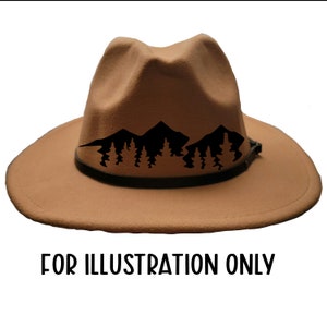 May include: Tan fedora hat with a black mountain and tree silhouette design. The hat has a wide brim and a black band around the crown. The text "FOR ILLUSTRATION ONLY" is printed below the hat.