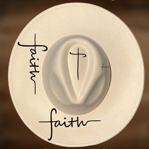 May include: A cream-coloured fedora hat with the word "faith" written in a script font on the side and a cross design on the crown. The text "For Hand Burning" and "CoolMoonDesigns" are also visible.