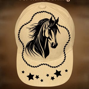 May include: Cream-colored baseball cap featuring a black horse head design within a rope border. The cap has a curved brim and includes the text "For Hand Burning" and "CoolMoonDesigns". Black stars are also featured.
