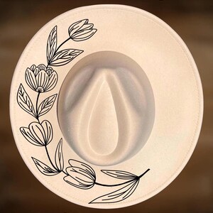 May include: Cream-colored fedora hat with a floral design. The hat features a black line drawing of flowers and leaves on the brim. The text "For Hand Burning" and "CoolMoonDesigns" are printed on the hat.