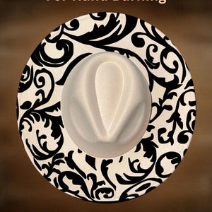 May include: A cream-colored fedora hat with a black and white swirling pattern around the brim. The text "For Hand Burning" and "CoolMoonDesigns" are printed on the image.