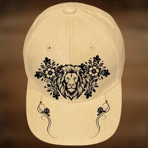 May include: A tan baseball cap featuring a black graphic of a lion surrounded by floral patterns on the front panel and two black rose vine designs on the brim. The text "For Hand Burning" appears at the top and "CoolMoonDesigns" at the bottom.