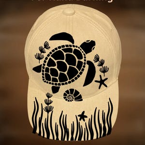 May include: A beige baseball cap with a black sea turtle design, seaweed, and starfish. The text "For Hand Burning" and "CoolMoonDesigns" are printed on the cap.