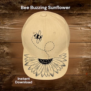 May include: A beige baseball cap featuring a black and white bee design with a dotted flight path. The cap's brim showcases a detailed black and white sunflower. The text "Bee Buzzing Sunflower" and "Instant Download" are also visible.