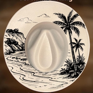 May include: Cream-coloured fedora hat with a beach scene design. The hat features a white crown and a wide brim with a black illustration of palm trees, waves, and a coastline. Text on the hat reads "For Hand Burning" and "CoolMoonDesigns".