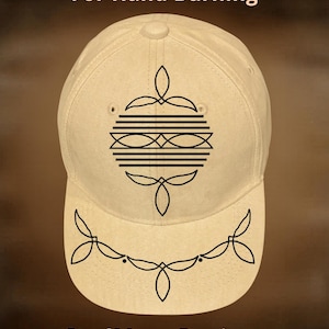 May include: A beige baseball cap with a black geometric design and the text "For Hand Burning" and "CoolMoonDesigns". The cap features a curved brim and a button on top.