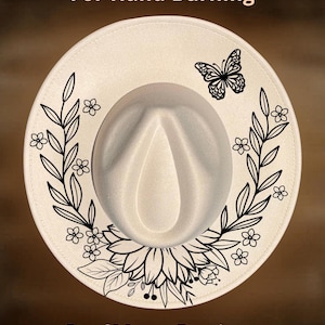 May include: A cream-coloured fedora hat with a black butterfly and floral design. The hat features the text "For Hand Burning" and "CoolMoonDesigns". The brim is decorated with a black floral wreath.