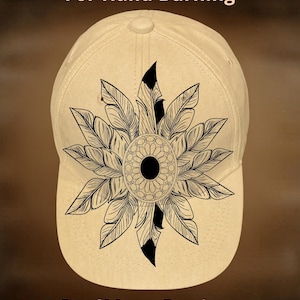 May include: Cream-colored baseball cap with a black and white feather design. The cap features the text "For Hand Burning" and "CoolMoonDesigns". The design is centered on the front of the cap.