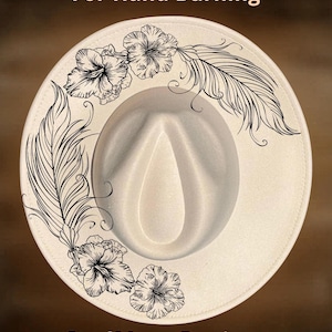 May include: Cream-colored fedora hat with a wide brim, featuring hand-burned floral and feather designs in black ink. The text "For Hand Burning" and "CoolMoonDesigns" are also visible on the hat.
