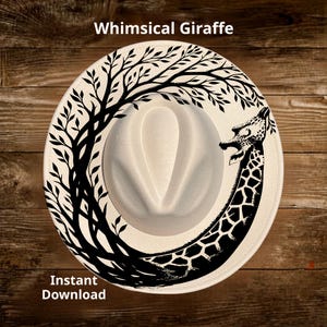 May include: A cream-colored fedora hat with a black giraffe design and tree branches. The hat has the text "Whimsical Giraffe" and "Instant Download". The hat is on a wooden surface.