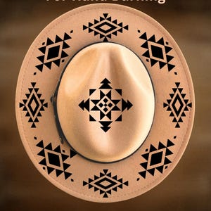 May include: A tan felt hat featuring a black geometric pattern printed on the crown and brim. The text "For Hand Burning" appears at the top, and "CoolMoonDesigns" is printed at the bottom. The hat has a dark band around the crown.
