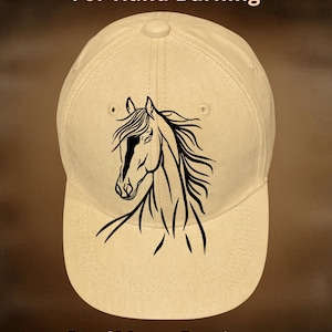 May include: A beige baseball cap with a black horse head design. The text "For Hand Burning" is above the cap, and "CoolMoonDesigns" is below. The cap has a curved brim and a button on top.