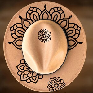 May include: A tan fedora-style hat with black floral mandala designs. The hat features the text "For Hand Burning" and "CoolMoonDesigns". The hat is a neutral color and suitable for various occasions.