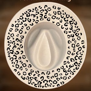 May include: Cream-colored fedora hat with a leopard print border. The hat features a classic teardrop crown and a wide brim. The text "For Hand Burning" and "CoolMoonDesigns" are printed on the hat.