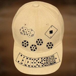 May include: Tan baseball cap with black graphics of dice, playing cards, and poker chips. The text "For Hand Burning" and "CoolMoonDesigns" are printed on the cap.
