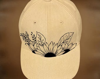 May include: A cream-coloured baseball cap featuring a black sunflower and foliage design. The text "For Hand Burning" is above the cap, and "CoolMoonDesigns" is below.