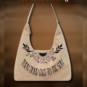May include: A beige hobo bag featuring a black line art illustration of a sunflower with leaves and the text "TURN YOUR FACE TO THE SUN". The image also includes the text "For Hand Burning" at the top and "CoolMoonDesigns" at the bottom.