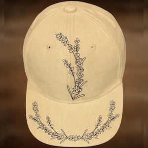 May include: A beige baseball cap with a curved brim, featuring a black floral design. The cap has the text "For Hand Burning" above the cap and "CoolMoonDesigns" below the cap.