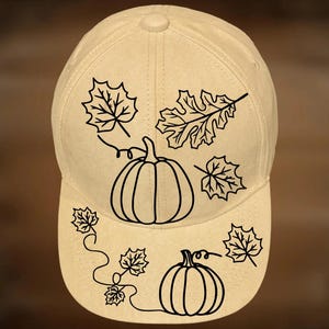 Op de afbeelding: Beige baseballpet met een zwart omtrekontwerp van pompoenen en bladeren. De tekst "For Hand Burning" staat boven de pet en "CoolMoonDesigns" eronder.