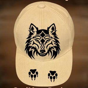 May include: A beige baseball cap featuring a black graphic of a wolf head centered on the front panel, with two black paw prints below the wolf. The text "For Hand Burning" appears at the top and "CoolMoonDesigns" is printed at the bottom.