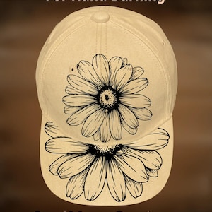 May include: A cream-coloured baseball cap with a black daisy design on the front and peak. The text "For Hand Burning" and "CoolMoonDesigns" are printed on the cap.