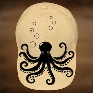 May include: A beige baseball cap featuring a black octopus design with bubbles. The text "For Hand Burning" is above the cap, and "CoolMoonDesigns" is below.