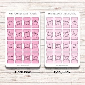 May include: Two sheets of planner tab stickers with a pink gradient. The top sheet has a darker pink gradient and the bottom sheet has a lighter pink gradient. Both sheets have the months of the year and the words "notes", "monthly", "weekly", and "daily" written on them.