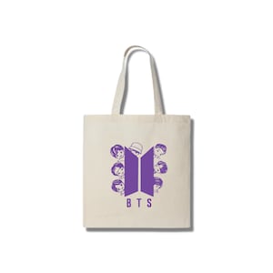 May include: A white tote bag featuring a purple BTS logo with the band members' faces peeking out from behind it.
