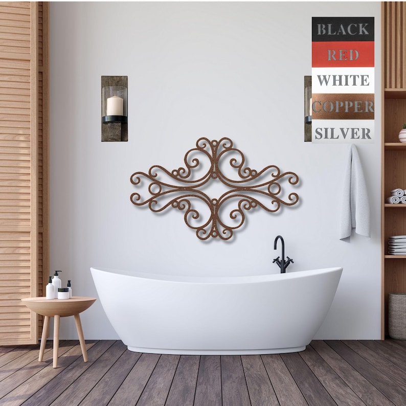 May include: A brown metal wall decor with a scroll design, hanging above a white bathtub in a bathroom. The wall decor is in the shape of a cross with four scrolls on each side. The bathroom has a white tiled floor and a white wall with a small candle holder on the wall.