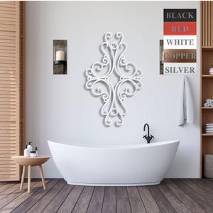 May include: White metal wall decor with a decorative scroll design. The decor is mounted on a white wall above a white bathtub.