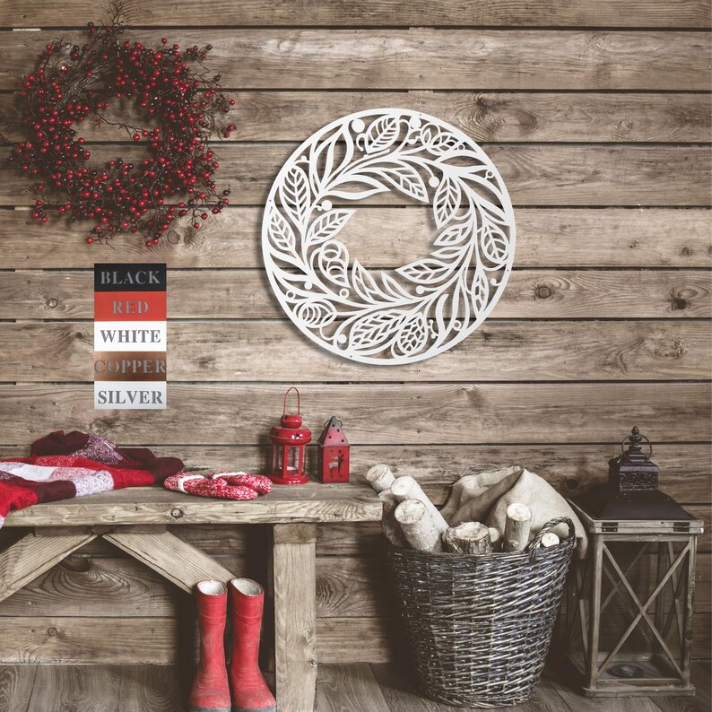 May include: White wooden wreath with a floral design. The wreath is hanging on a rustic wooden wall. The words "BLACK", "RED", "WHITE", "COPPER", and "SILVER" are written on a white strip of paper.