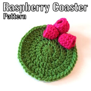 May include: Green crocheted coaster with three pink crocheted raspberries on top. Raspberry Coaster Pattern.