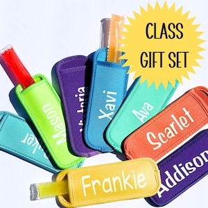 May include: A set of eight colorful, personalized popsicle holders with names printed in white. The holders are made of a soft, neoprene-like material and are designed to keep popsicles cold and prevent drips. The set is labeled "CLASS GIFT SET".