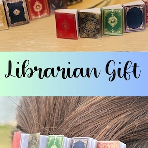 May include: A set of four hair clips featuring miniature book designs. The books are decorated with various patterns and colors, including red, green, blue, and gold. The clips are a fun and unique accessory for book lovers, librarians, and reading teachers.