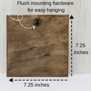 May include: A brown wooden square sign with a metal hanging hook. The sign measures 7.25 inches by 7.25 inches.