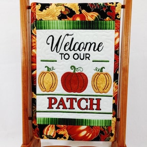 A Cherry stand and frame for display of embroidered banner.