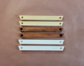 May include: Five wooden shelf brackets, two are natural wood, two are stained brown, and one is painted white.