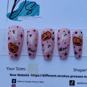 Cute pink Halloween nails with ghosts and pumpkins