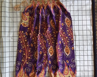May include: Purple, gold, and red patterned pants with an elastic waistband. The pants have a peacock feather design.