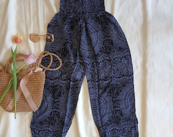 May include: Blue and white patterned pants with an elastic waistband. The pants are made of a lightweight fabric and have a flowing silhouette.