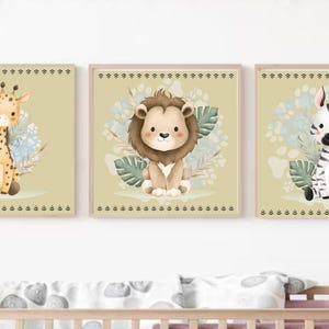 May include: Set of three framed nursery art prints featuring adorable cartoon animals: a giraffe, a lion, and a zebra. Each animal is surrounded by floral and leaf accents, set against a soft green background. The frames have a decorative border.