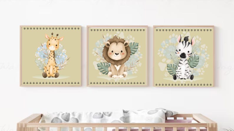 May include: Set of three framed nursery art prints featuring adorable cartoon animals: a giraffe, a lion, and a zebra. Each animal is surrounded by floral and leaf accents, set against a soft green background. The frames have a decorative border.