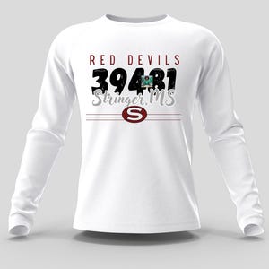 May include: White long-sleeve shirt with the text "RED DEVILS 39481 Stringer, MS". The design includes a maroon "S" logo and horizontal lines. The shirt has a crew neck and long sleeves.