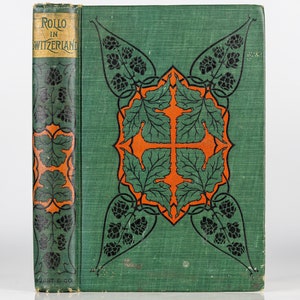 Puede incluir: Un libro verde con un título que dice "ROLLO EN SUIZA". La portada presenta un diseño decorativo de hojas naranjas y negras y una cruz.