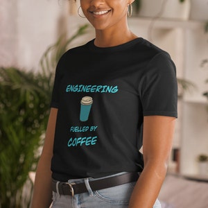 May include: Black t-shirt with the text "ENGINEERING FUELLED BY COFFEE" in white and a blue coffee cup graphic.