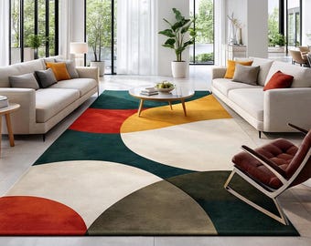 May include: A modern area rug with a geometric design. The rug features large, overlapping semi-circles in red, yellow, cream, green, and brown. The rug is placed in a living room with white sofas and large windows.